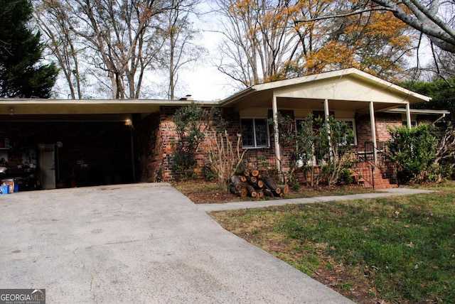 ranch-style house with a front yard and a carport