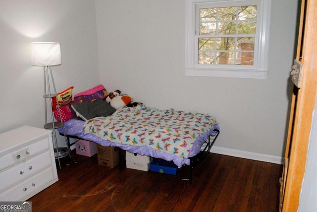 bedroom with dark hardwood / wood-style floors