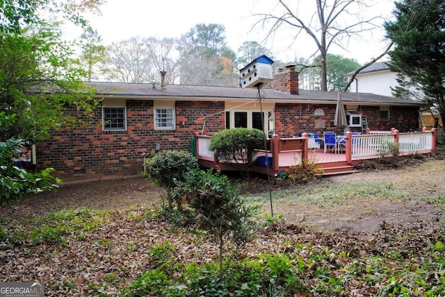 rear view of property with a wooden deck