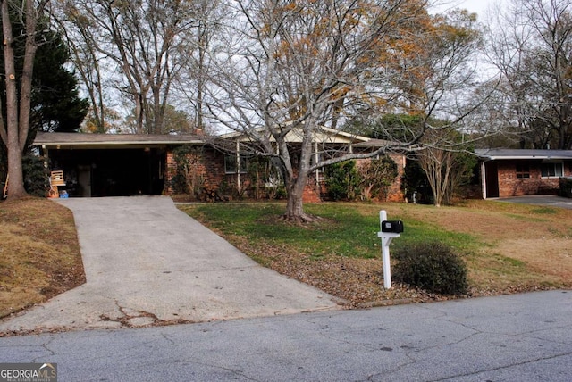 view of front facade with a front yard and a carport