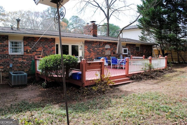 back of property featuring central air condition unit and a wooden deck