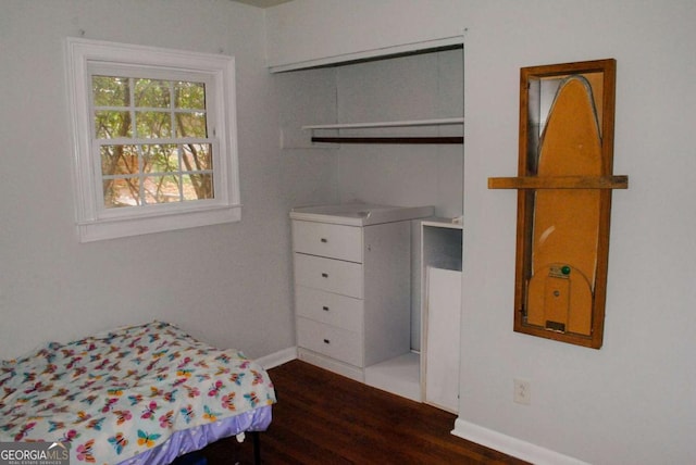 bedroom with dark wood-type flooring