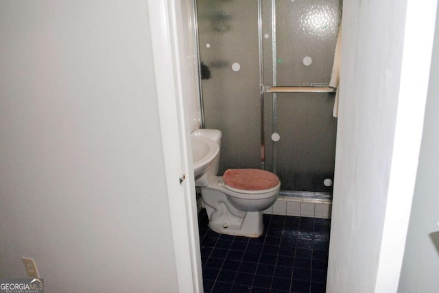 bathroom with tile patterned flooring, an enclosed shower, and toilet