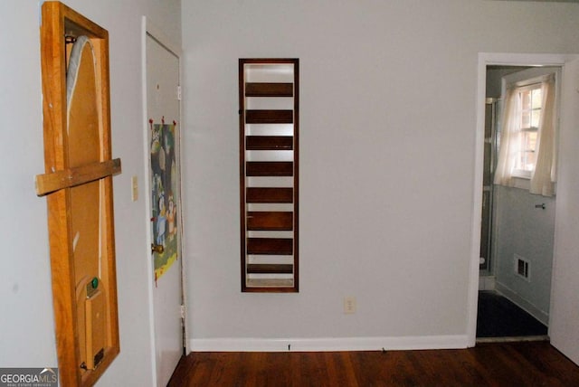 corridor featuring dark hardwood / wood-style flooring