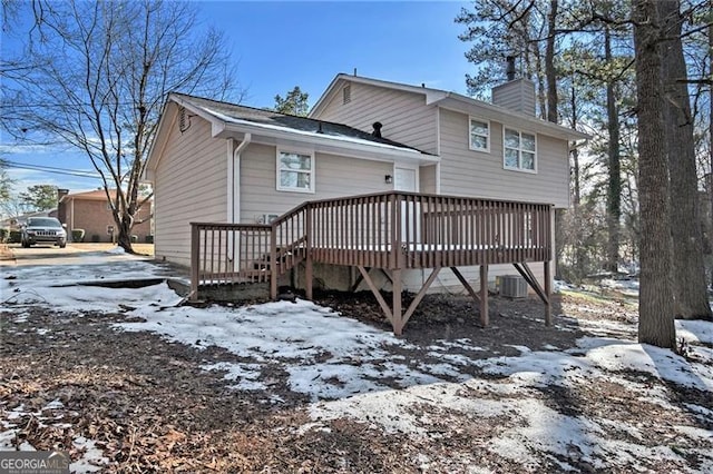 snow covered property featuring a wooden deck and cooling unit