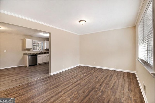 unfurnished room with plenty of natural light, crown molding, and dark hardwood / wood-style floors