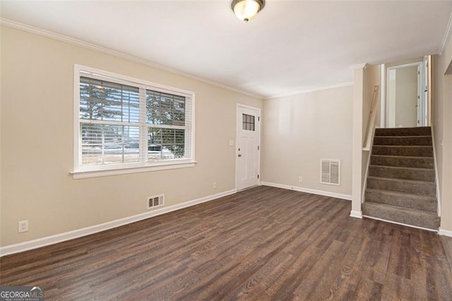 entrance foyer with dark hardwood / wood-style flooring and crown molding