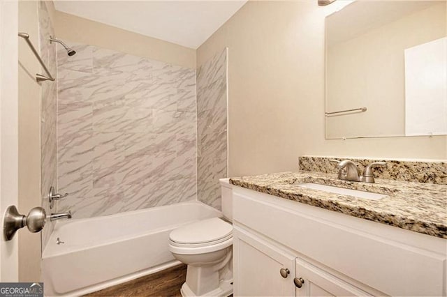 full bathroom with toilet, vanity, tiled shower / bath combo, and hardwood / wood-style flooring