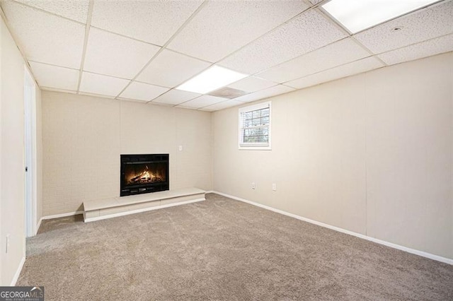 basement featuring carpet flooring and a drop ceiling