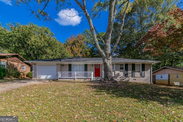 ranch-style house with a front yard, a garage, and a porch