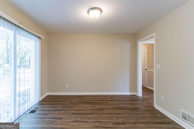 unfurnished room featuring dark hardwood / wood-style floors