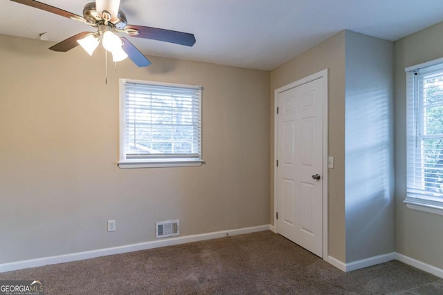 carpeted empty room featuring ceiling fan