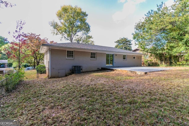 back of house featuring central AC, a yard, and a patio