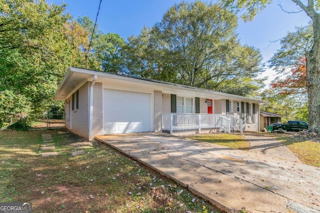 single story home with a porch and a garage