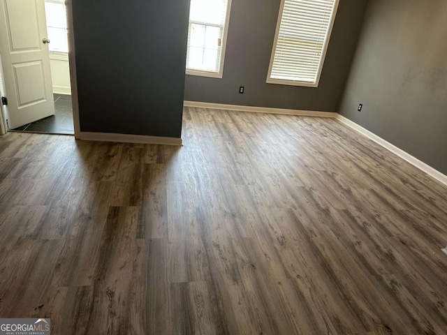 unfurnished room featuring dark hardwood / wood-style flooring