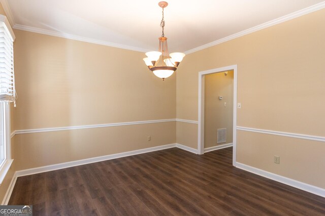 empty room with a notable chandelier, dark wood-type flooring, and crown molding