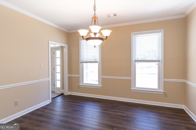 spare room with an inviting chandelier, crown molding, and dark hardwood / wood-style flooring