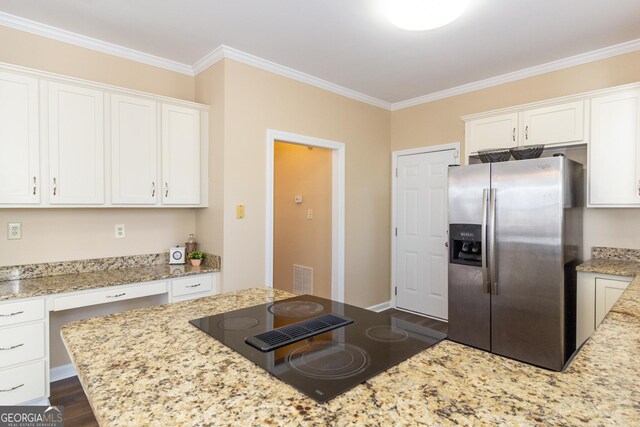 kitchen featuring light stone counters, white cabinets, black electric stovetop, and stainless steel fridge with ice dispenser