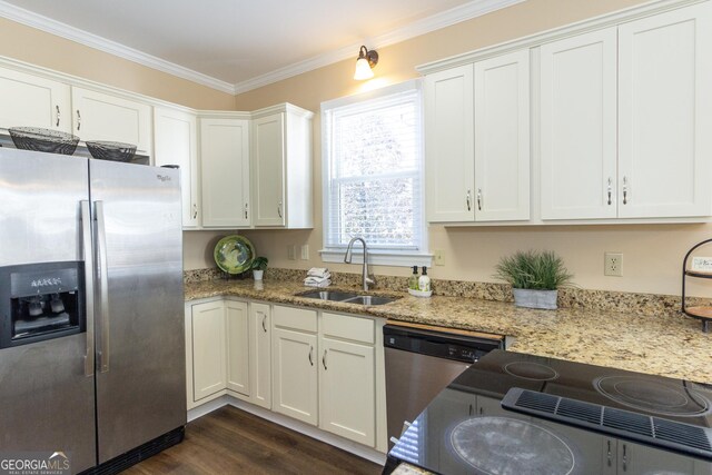 kitchen featuring light stone counters, stainless steel appliances, white cabinetry, and sink