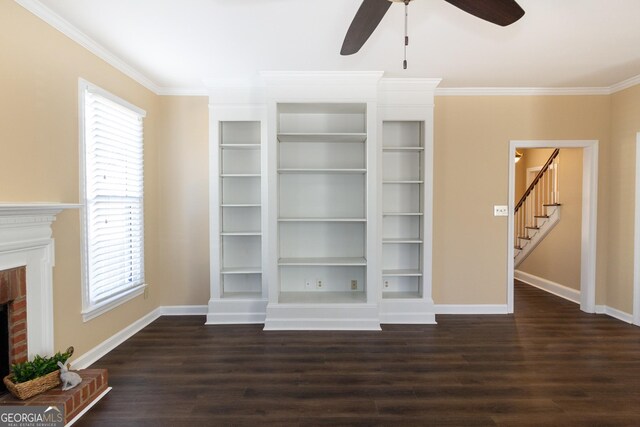 unfurnished living room with dark hardwood / wood-style flooring, a fireplace, plenty of natural light, and crown molding