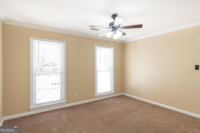 carpeted empty room with ceiling fan and crown molding