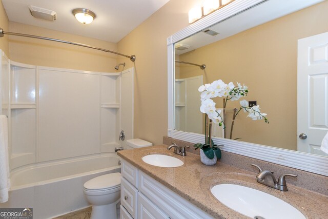 full bathroom featuring shower / bathing tub combination, vanity, and toilet