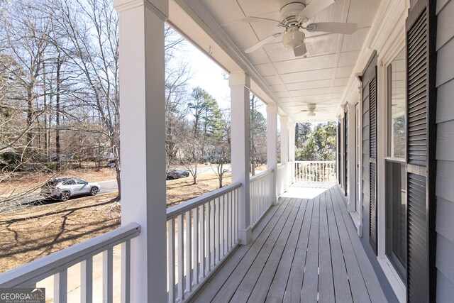 wooden deck featuring ceiling fan and a porch