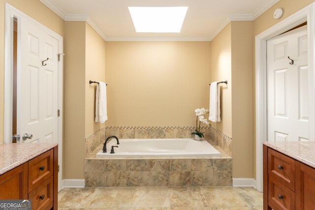 bathroom featuring vanity, a skylight, tiled bath, and crown molding