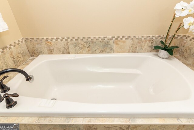 bathroom featuring tiled tub