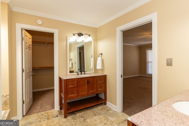 bathroom with crown molding and vanity