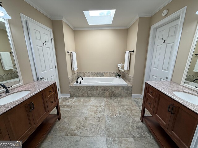 bathroom with a relaxing tiled tub, a skylight, crown molding, and vanity