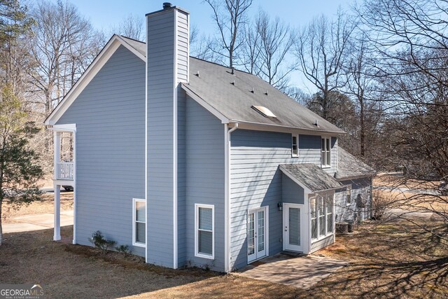 view of side of home featuring french doors and cooling unit