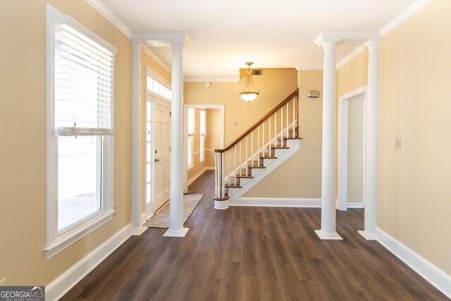 entrance foyer featuring decorative columns, crown molding, and dark hardwood / wood-style floors