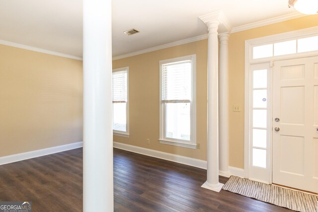 entryway with dark hardwood / wood-style flooring, ornamental molding, and decorative columns