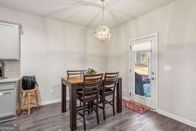 dining room featuring an inviting chandelier and dark hardwood / wood-style floors