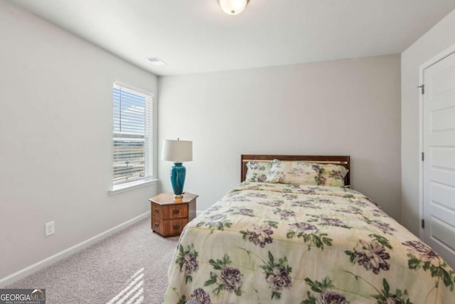 bedroom featuring light carpet