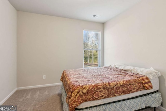 bedroom with light colored carpet