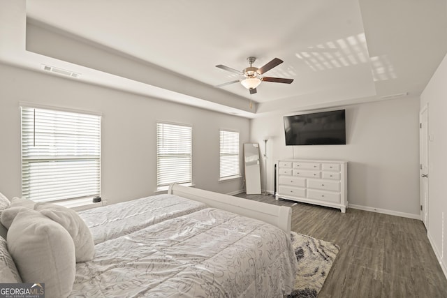 bedroom with ceiling fan and dark hardwood / wood-style flooring