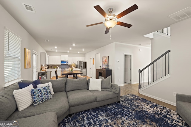 living room featuring hardwood / wood-style flooring and ceiling fan