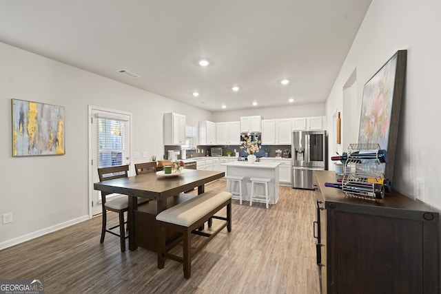 dining space featuring light wood-type flooring