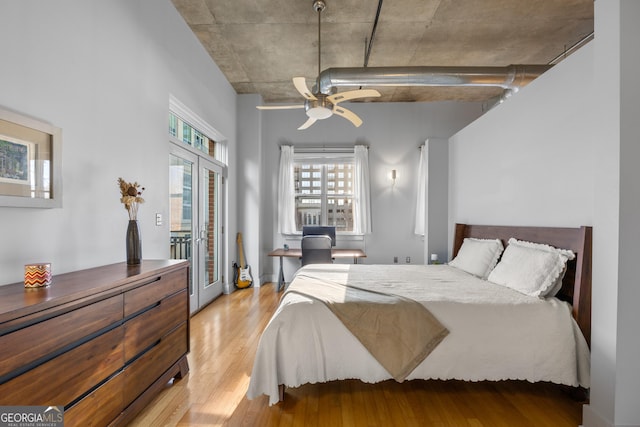 bedroom with ceiling fan, light wood-type flooring, french doors, and access to exterior