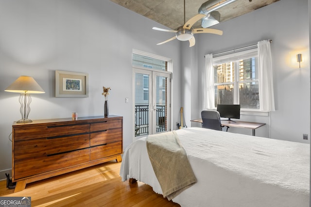 bedroom featuring ceiling fan, light hardwood / wood-style flooring, french doors, and access to outside