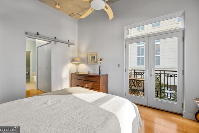 bedroom featuring access to outside, light wood-type flooring, french doors, and ceiling fan