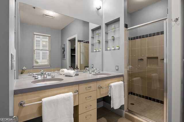 bathroom featuring a shower with door, tile patterned floors, and vanity