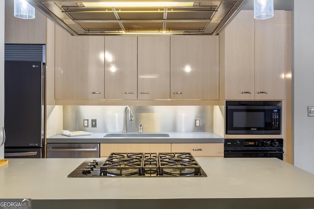 kitchen featuring black appliances, sink, and light brown cabinets