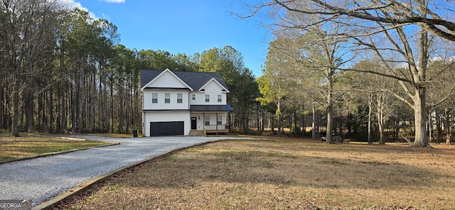 view of front of house with a garage and a front yard