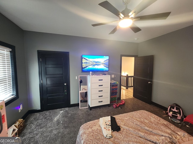 bedroom with ceiling fan, dark colored carpet, and baseboards