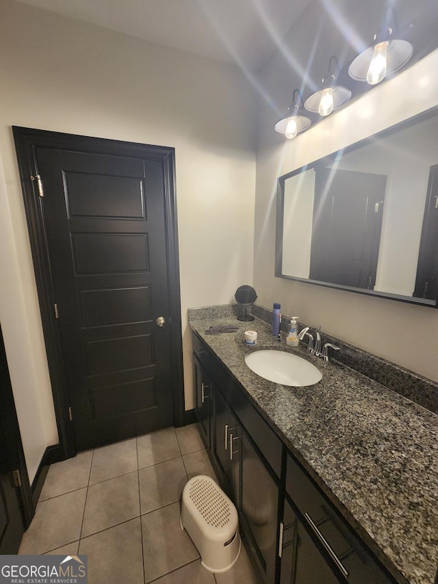 bathroom featuring tile patterned flooring, baseboards, and vanity