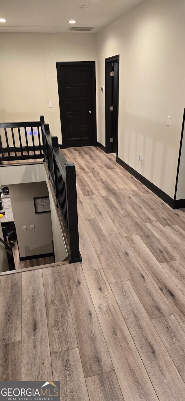 interior space with light wood-type flooring, baseboards, and recessed lighting