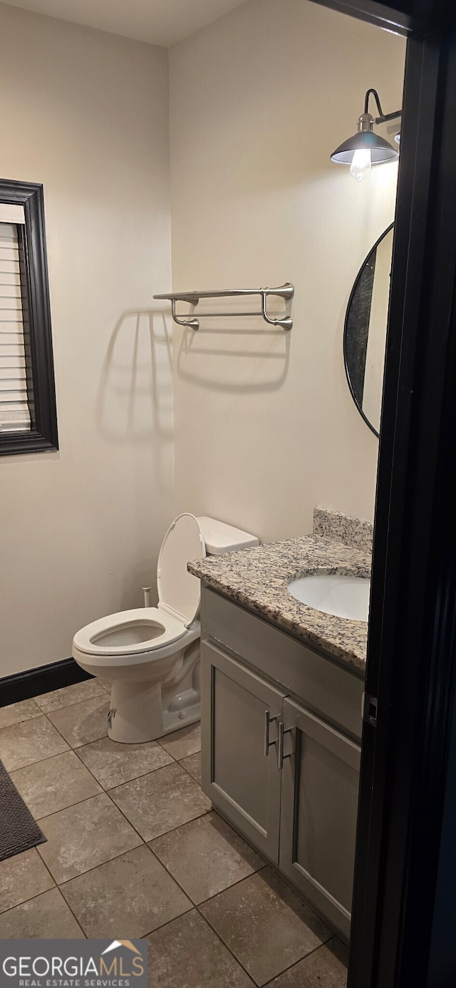 half bathroom with vanity and toilet